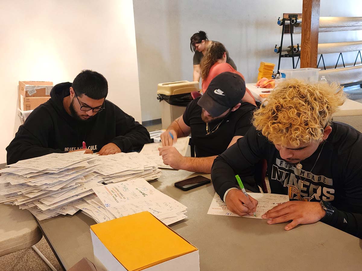 MACU students writing letters for Ferocious Fighter Kits for children with CRPS